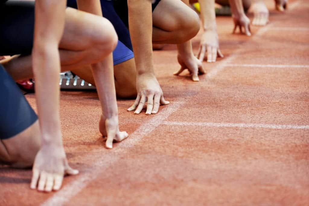 athletes on start line of athletics track