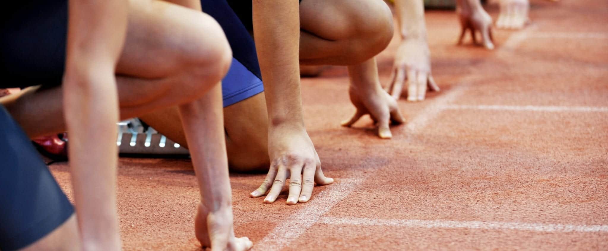 Athletes at the sprint start line in track and field