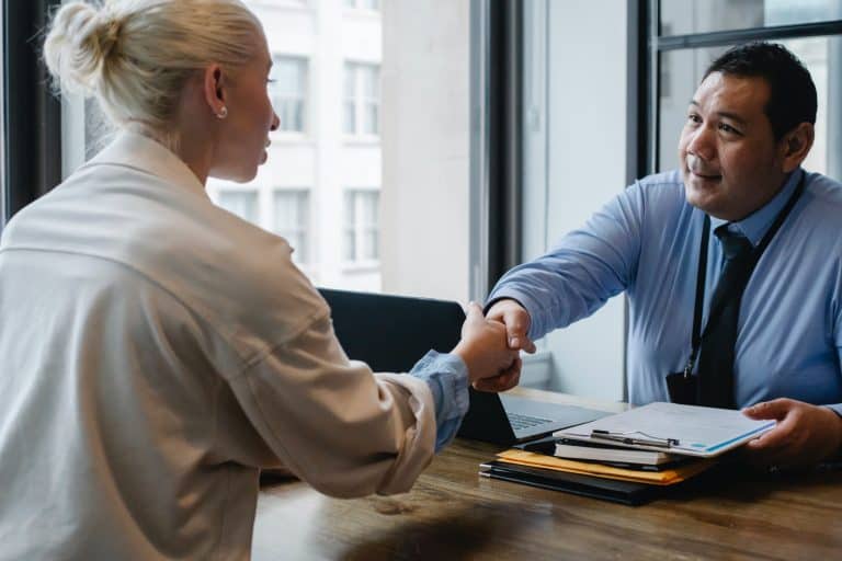 two people shaking hands in interview style